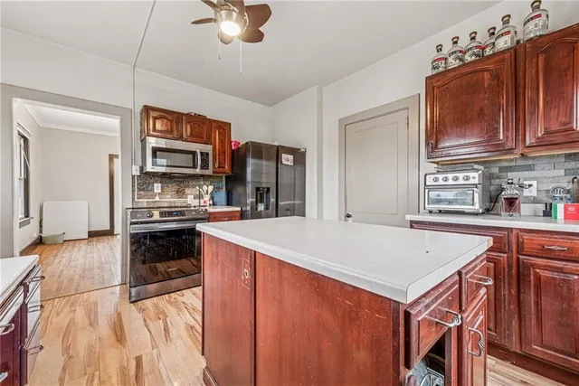a kitchen with a stove a sink and a refrigerator