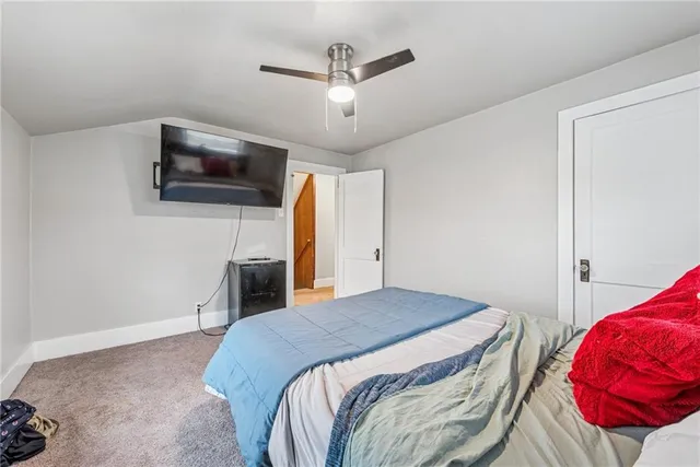 a bedroom with a bed and a television