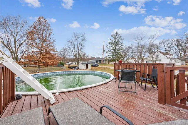 a roof deck with table and chairs and wooden floor