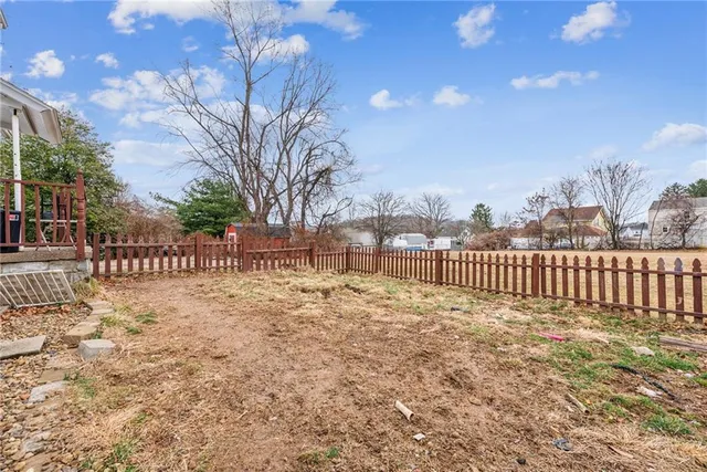 a view of a street with a fence