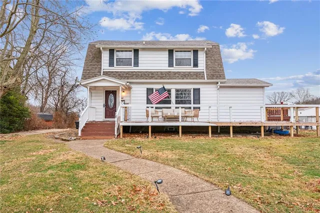 a view of a house with a yard and sitting area