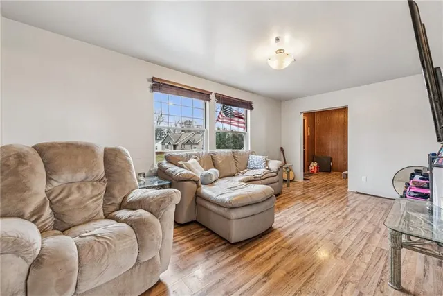 a living room with furniture a couch and a window