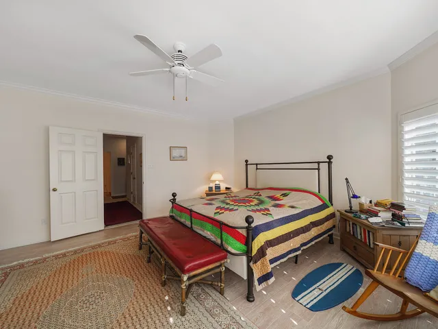 a bedroom with bed and a table