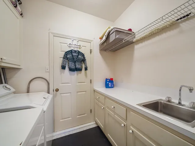 a kitchen with a sink and a stove top oven