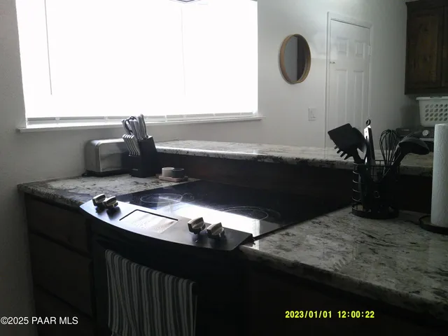 a kitchen with a stove a sink and a window