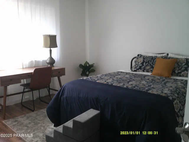 a bedroom with a bed and a lamp on table