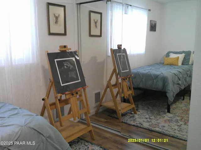 a bedroom with furniture and a window