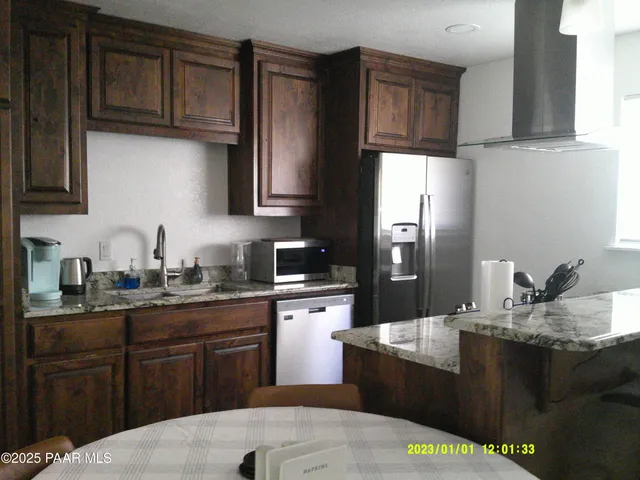 a kitchen with a sink a stove and refrigerator