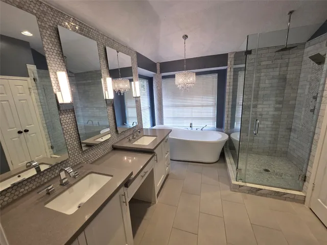 a bathroom with a double vanity sink mirror and shower