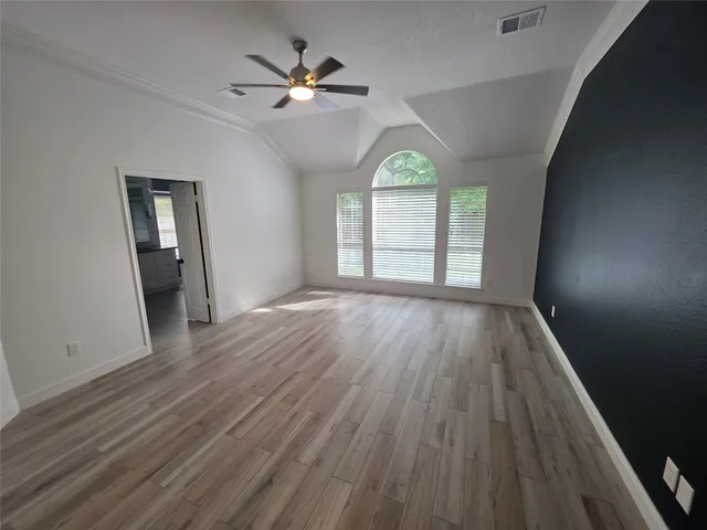 wooden floor in an empty room with a window