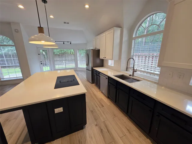 a kitchen that has a lot of cabinets in it