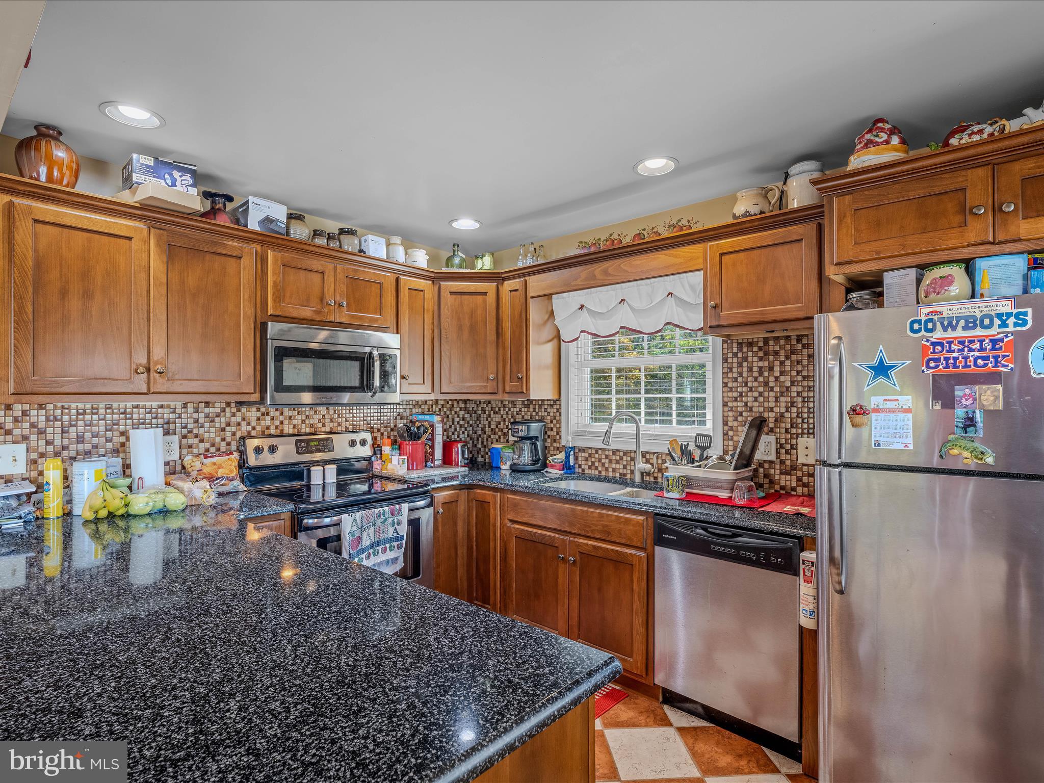 608 DeHaven Road Berkeley Springs, WV 25411 - Photo 11 of 52 a kitchen with stainless steel appliances granite countertop a sink stove and cabinets