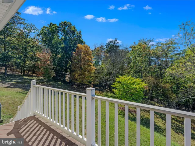 a view of balcony with wooden floor and fence