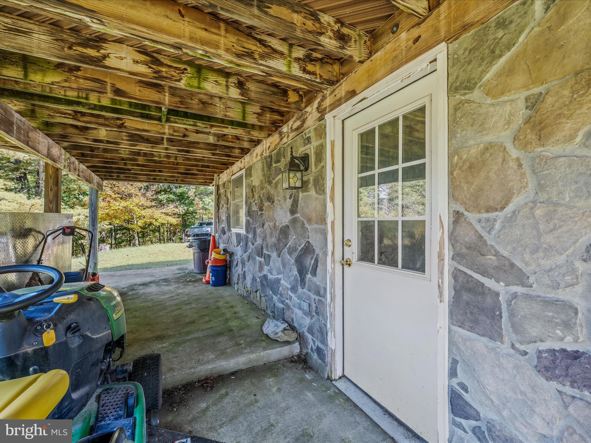 608 DeHaven Road Berkeley Springs, WV 25411 - Photo 26 of 52 a view of a porch with furniture and floor to ceiling window