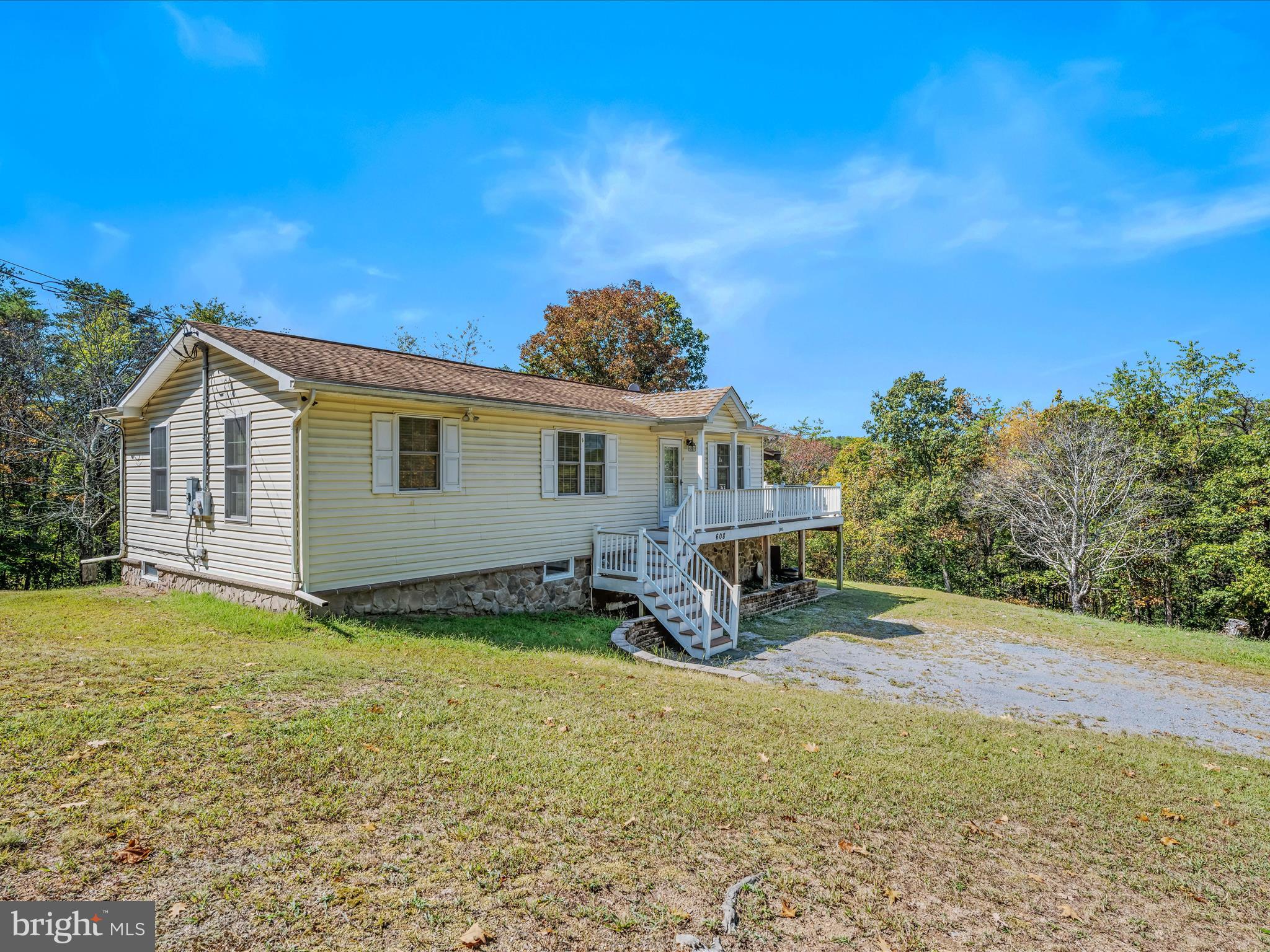 608 DeHaven Road Berkeley Springs, WV 25411 - Photo 29 of 52 a view of a house with backyard and sitting area