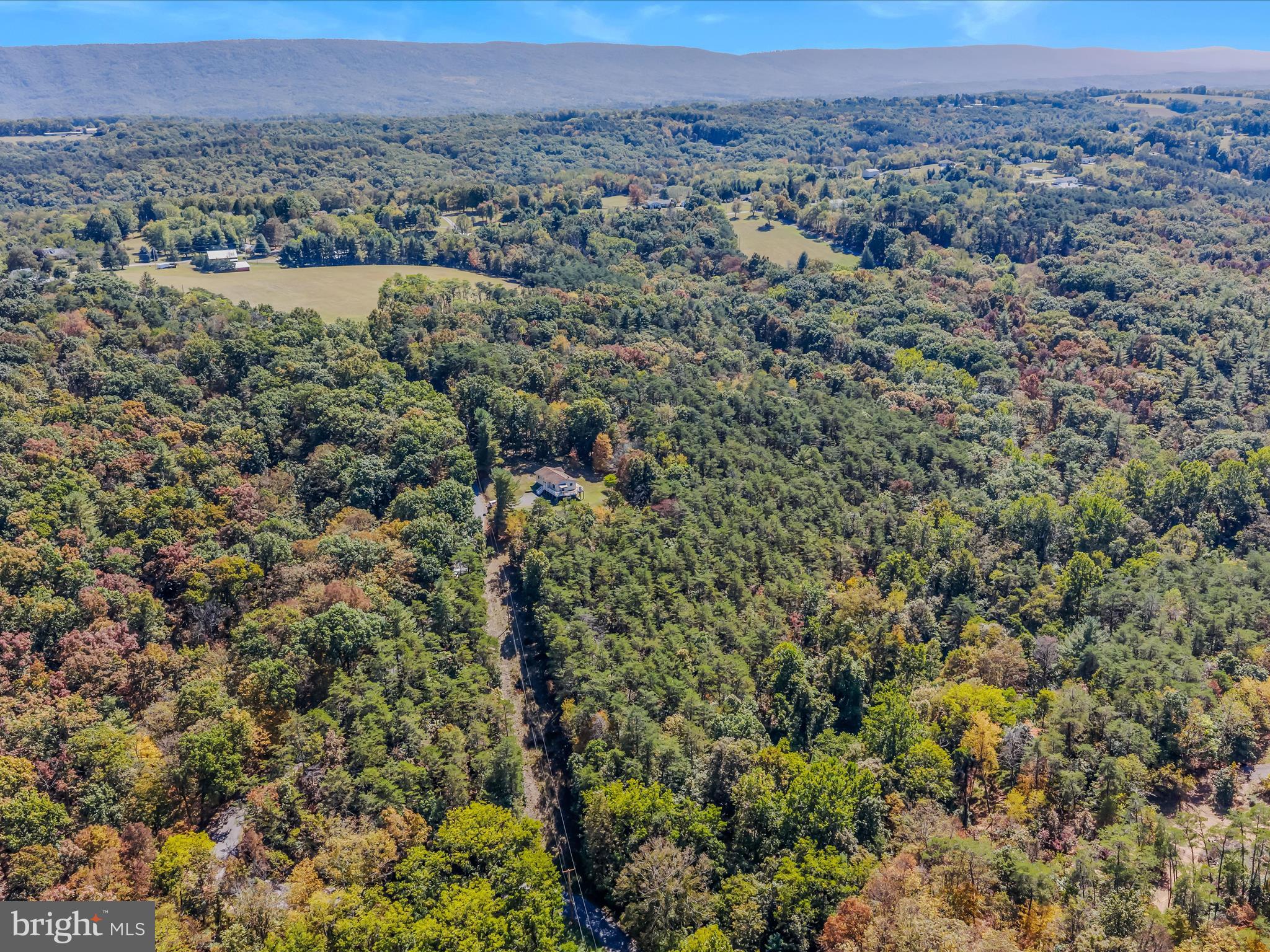608 DeHaven Road Berkeley Springs, WV 25411 - Photo 49 of 52 an aerial view of a houses with a lush green hillside