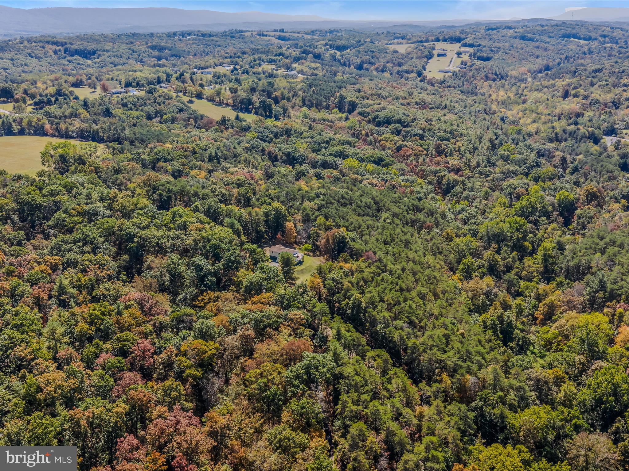 608 DeHaven Road Berkeley Springs, WV 25411 - Photo 50 of 52 an aerial view of a houses with a lush green hillside