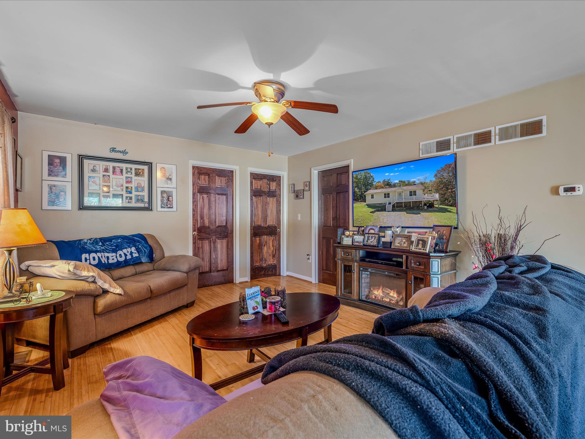608 DeHaven Road Berkeley Springs, WV 25411 - Photo 5 of 52 a living room with furniture a flat screen tv and a fireplace
