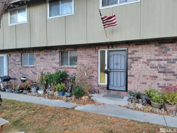 a view of brick building with potted plants