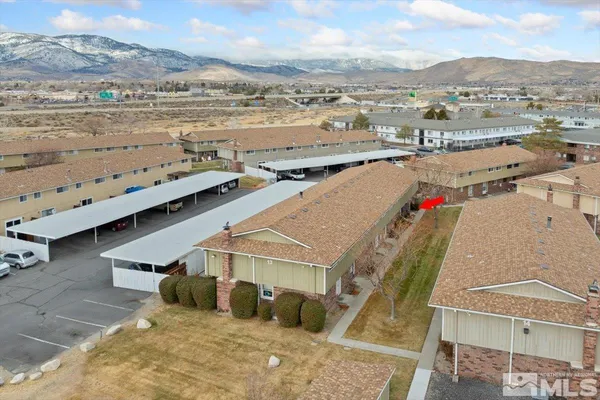 an aerial view of residential houses with outdoor space and ocean view