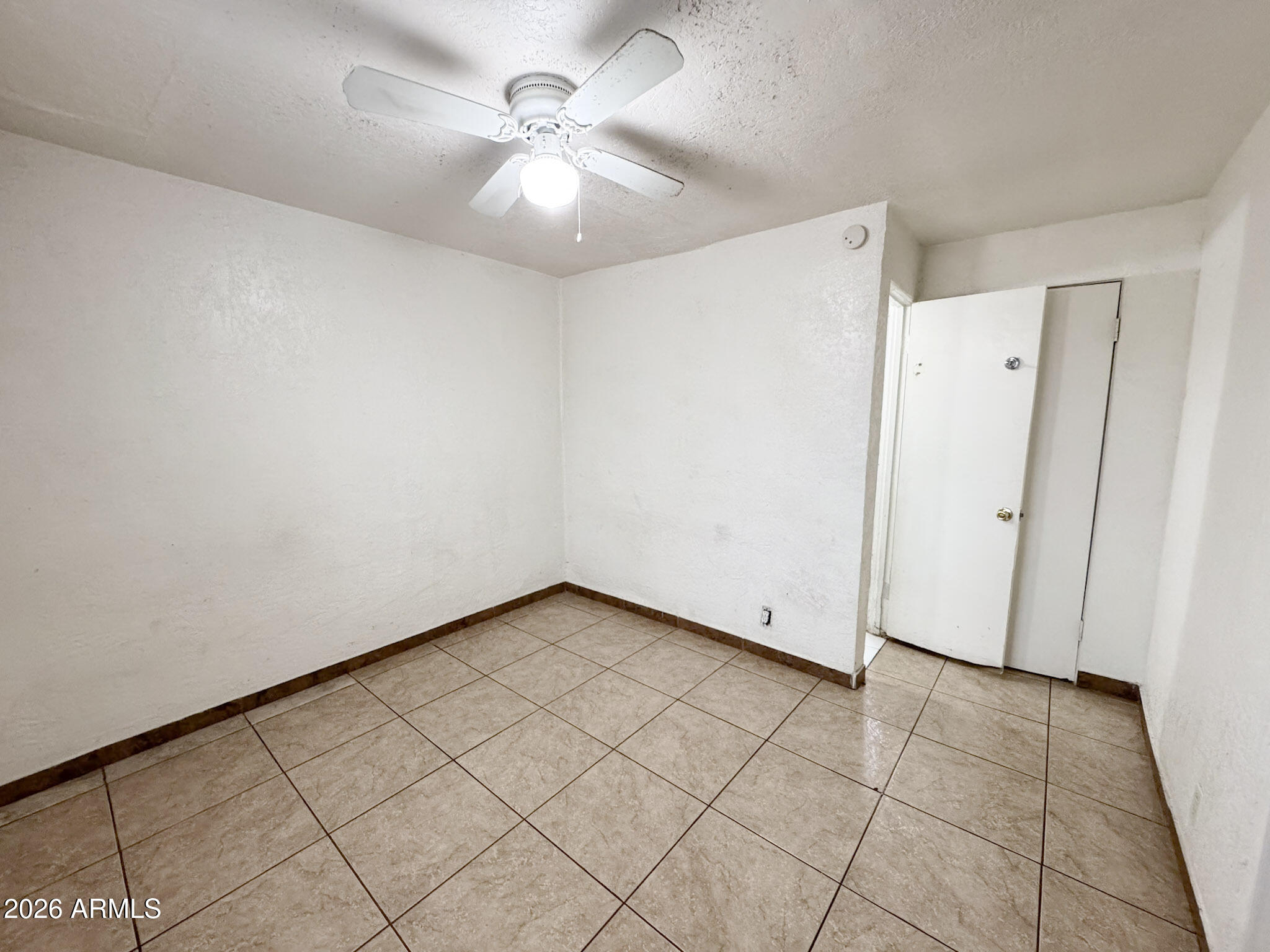3601 West Melvin Street, Unit 7 Phoenix, AZ 85009 - Photo 9 of 26 an empty room with fan