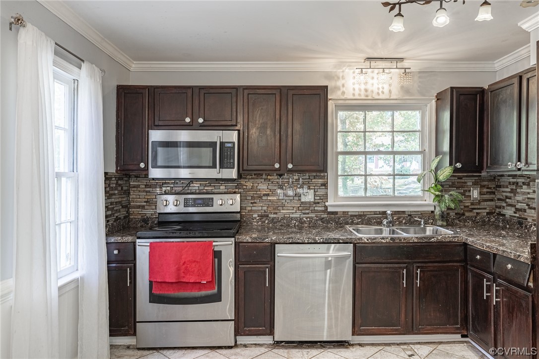 11701 Deerhurst Drive Midlothian, VA 23113 - Photo 5 of 22 a kitchen with stainless steel appliances granite countertop a stove sink and microwave