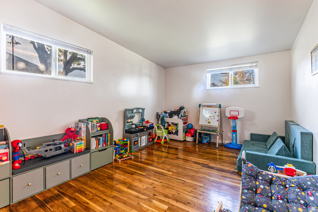 1619 Davis Drive Layton, UT 84041 - Photo 14 of 27 Hardwood flooring throughout a spacious room with light-colored walls