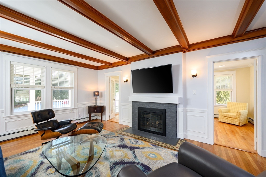 1099 Brook Road Milton, MA 02186 - Photo 5 of 41 a living room with furniture a fireplace and a flat screen tv