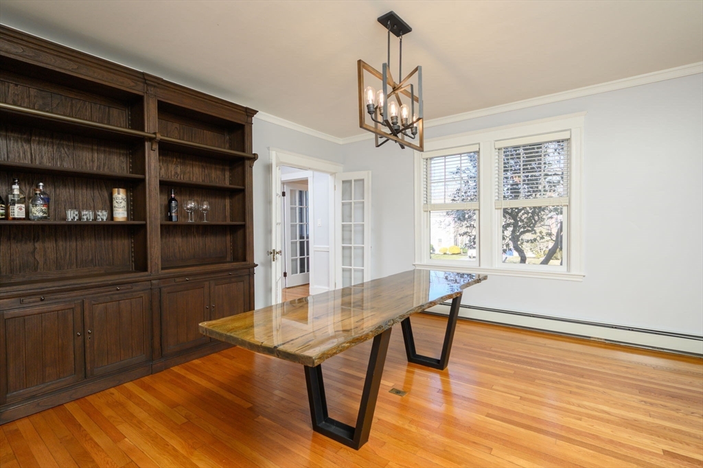 1099 Brook Road Milton, MA 02186 - Photo 7 of 41 a view of a dining room with furniture and wooden floor
