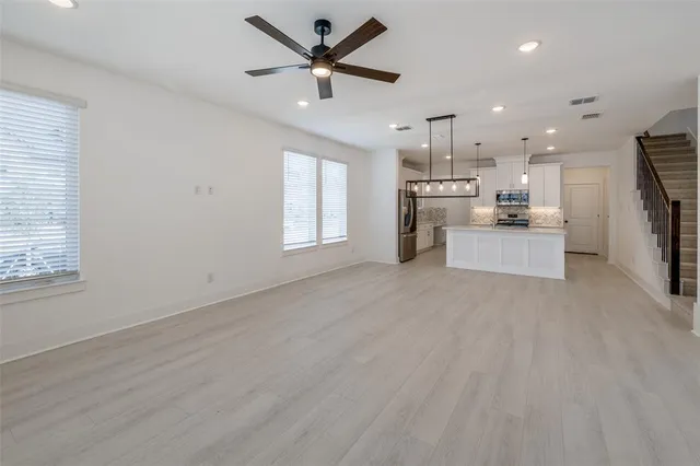 a view of a kitchen with a sink a refrigerator and window