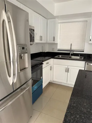 a view of a kitchen with a sink and a window