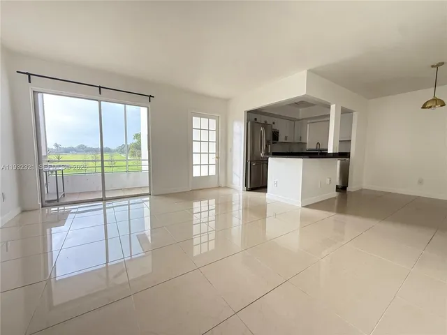 a kitchen with stainless steel appliances a refrigerator sink and stove