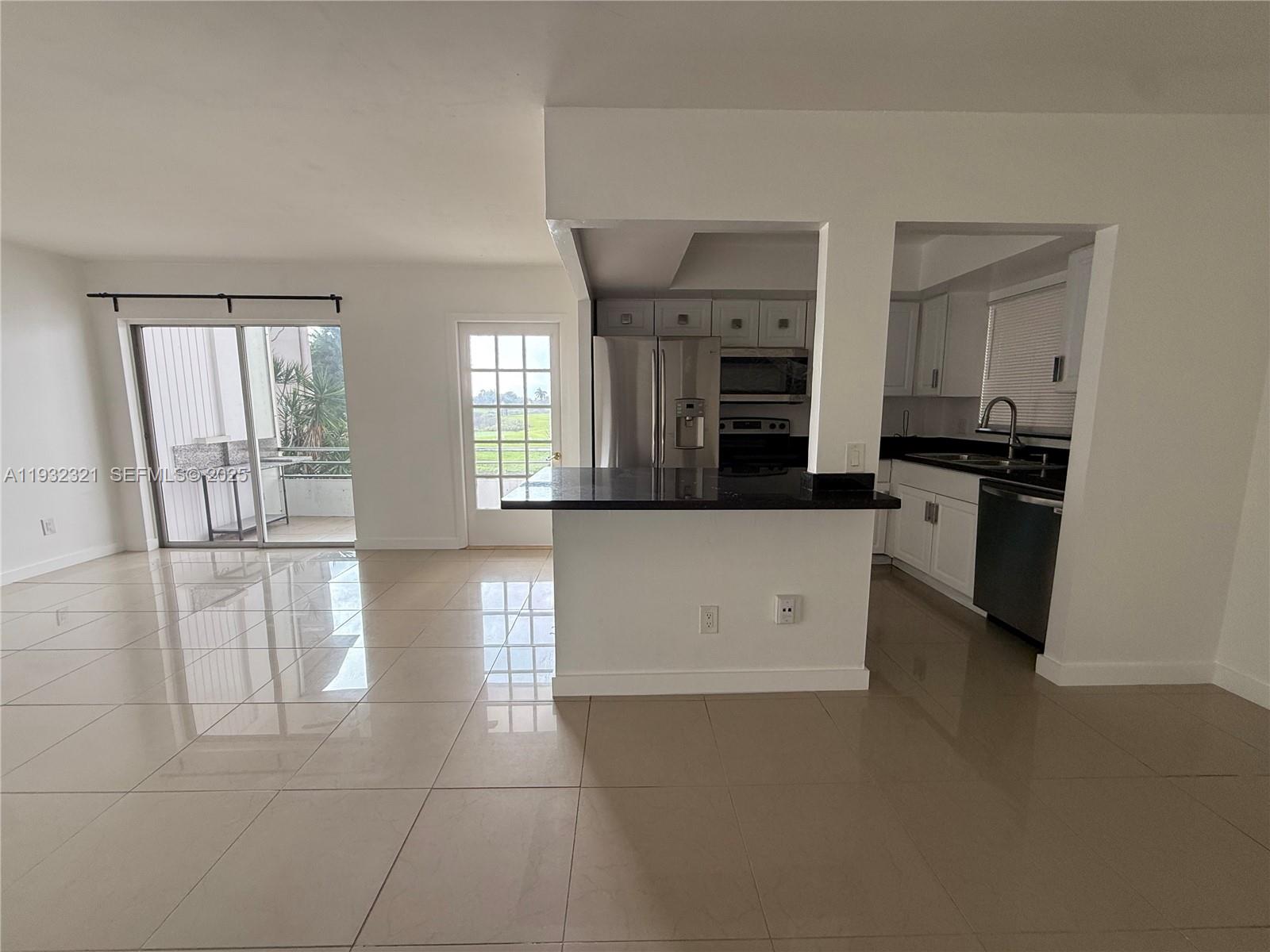 Arrowhead Condominium Davie, FL 33324 - Photo 29 of 35 a kitchen with stainless steel appliances a refrigerator sink and stove