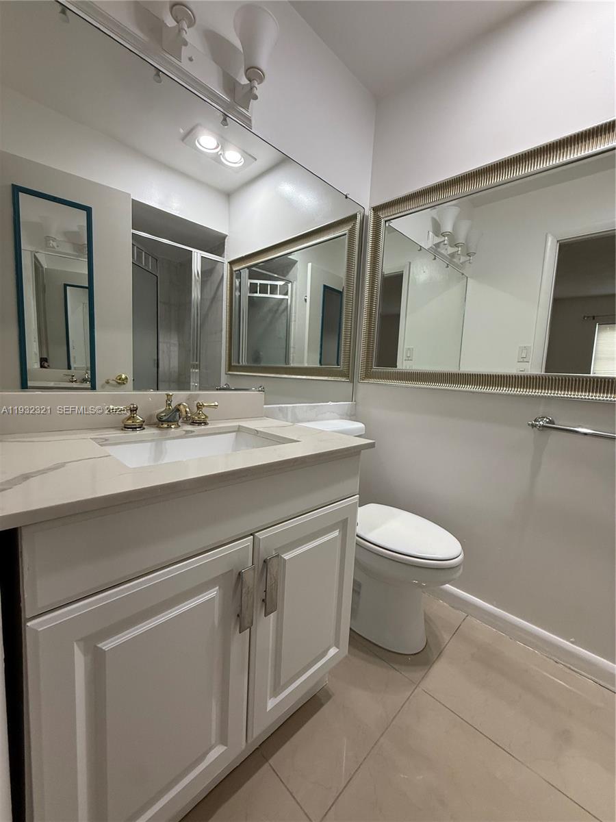 Arrowhead Condominium Davie, FL 33324 - Photo 8 of 35 a bathroom with a sink toilet and mirror