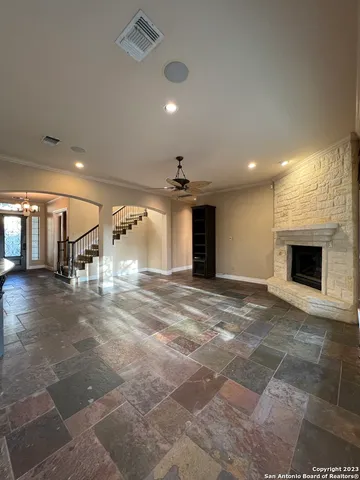 a view of a hall with a dining table and chairs