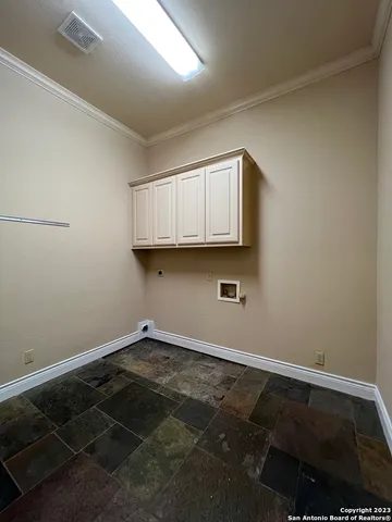 a room with a sink and cabinets