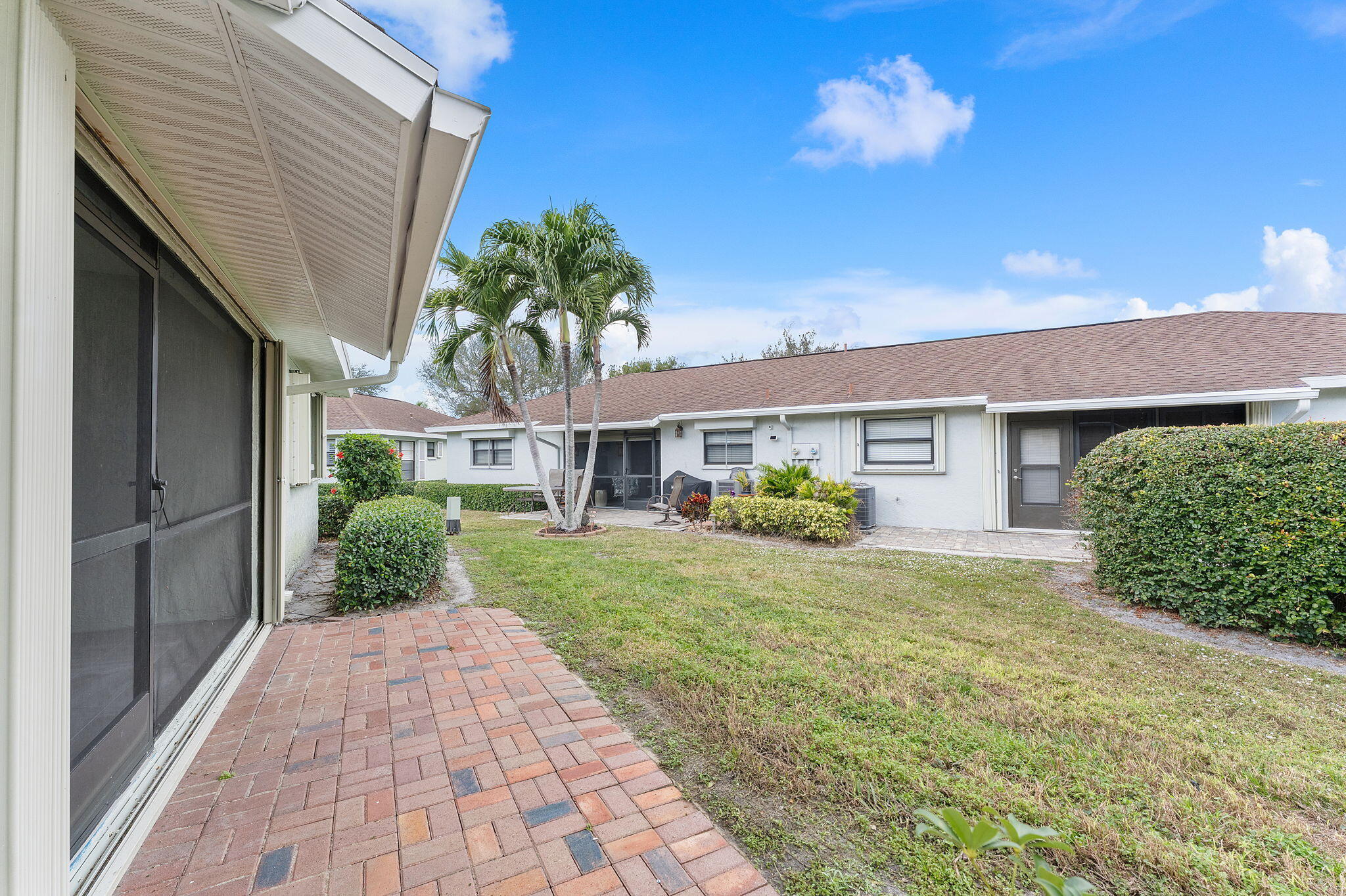 9840 Chestnut Tree Terrace, Unit A Boynton Beach, FL 33436 - Photo 15 of 27 a front view of a house with garden