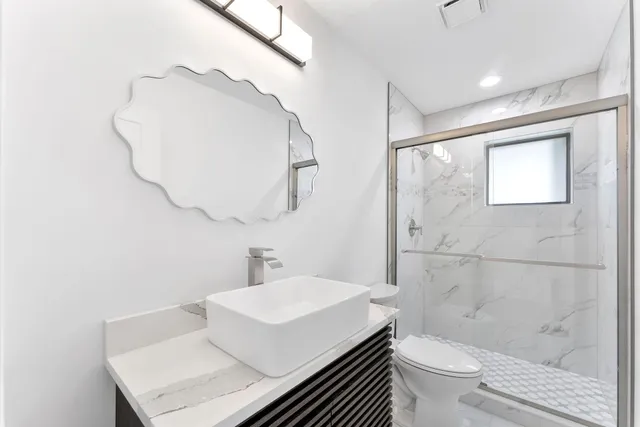 a bathroom with a sink toilet and shower