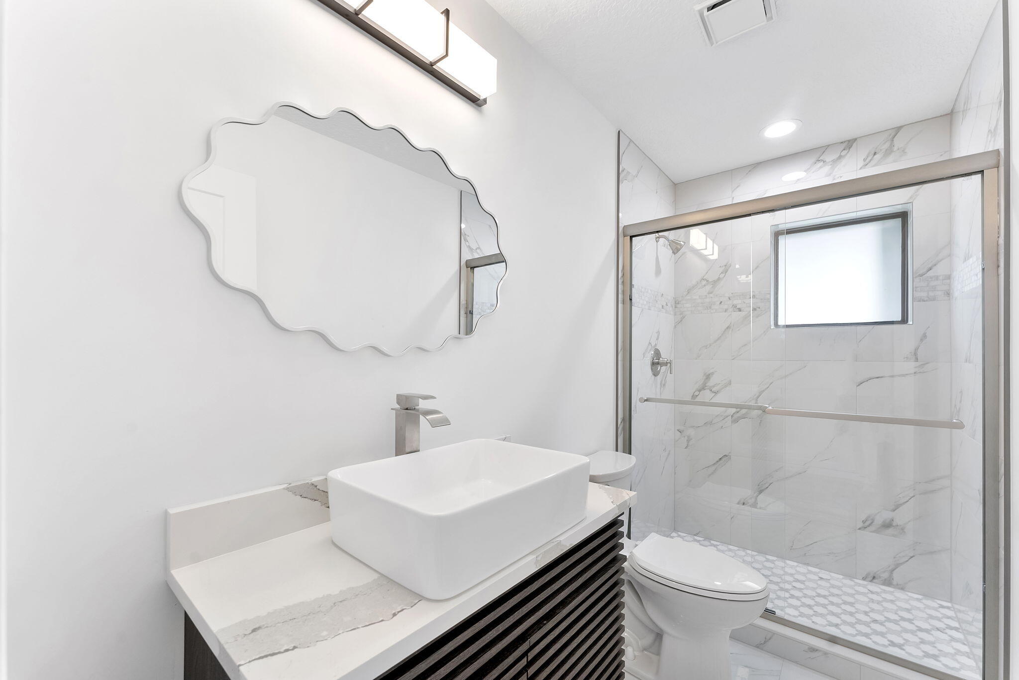 9840 Chestnut Tree Terrace, Unit A Boynton Beach, FL 33436 - Photo 19 of 27 a bathroom with a sink toilet and shower