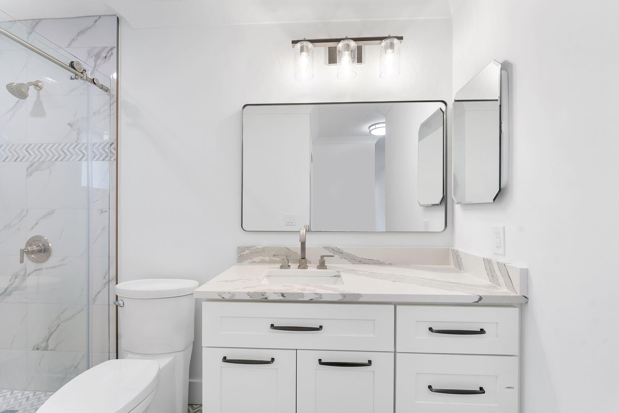 9840 Chestnut Tree Terrace, Unit A Boynton Beach, FL 33436 - Photo 21 of 27 a bathroom with a granite countertop sink a toilet and shower