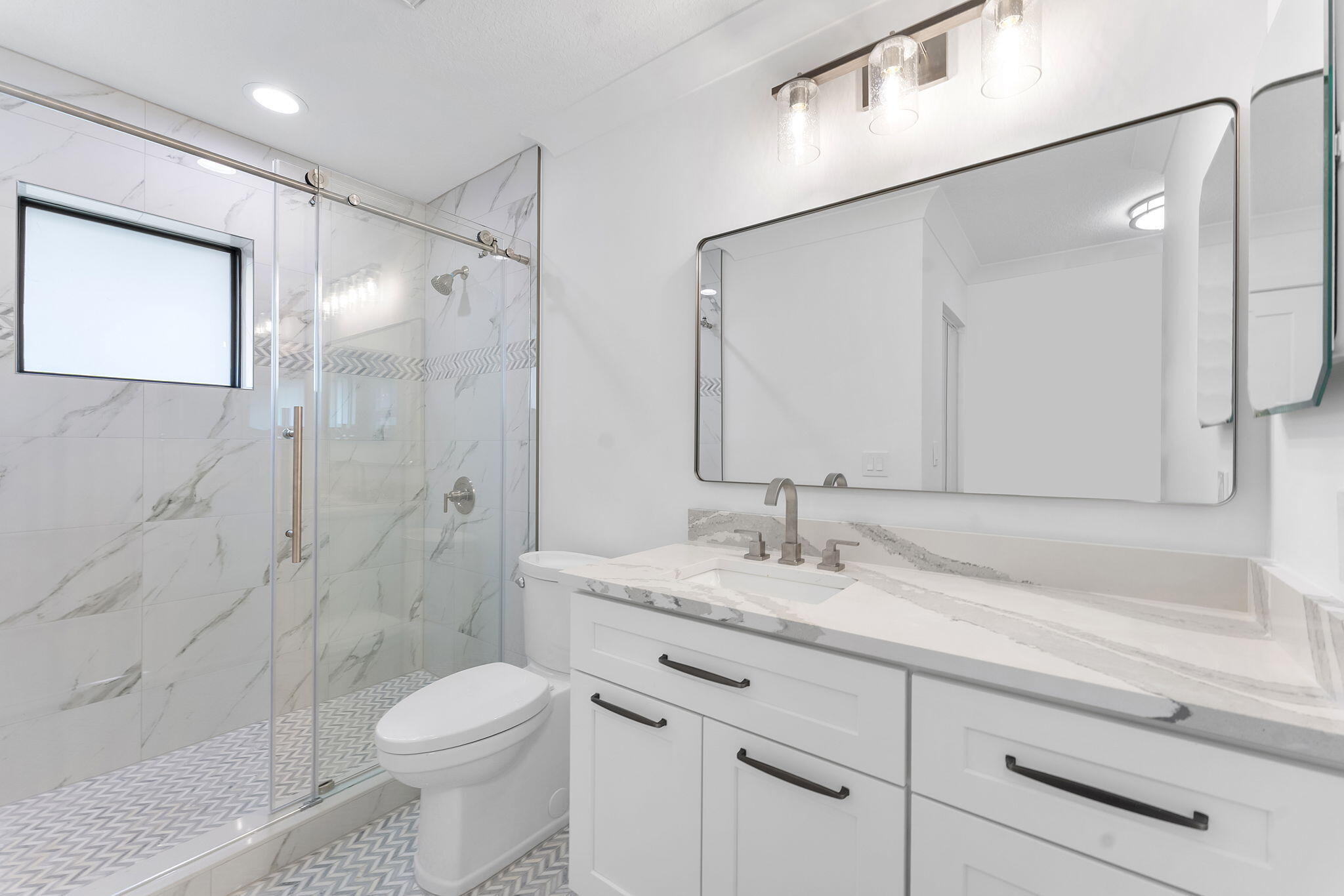 9840 Chestnut Tree Terrace, Unit A Boynton Beach, FL 33436 - Photo 22 of 27 a bathroom with a sink a toilet and shower