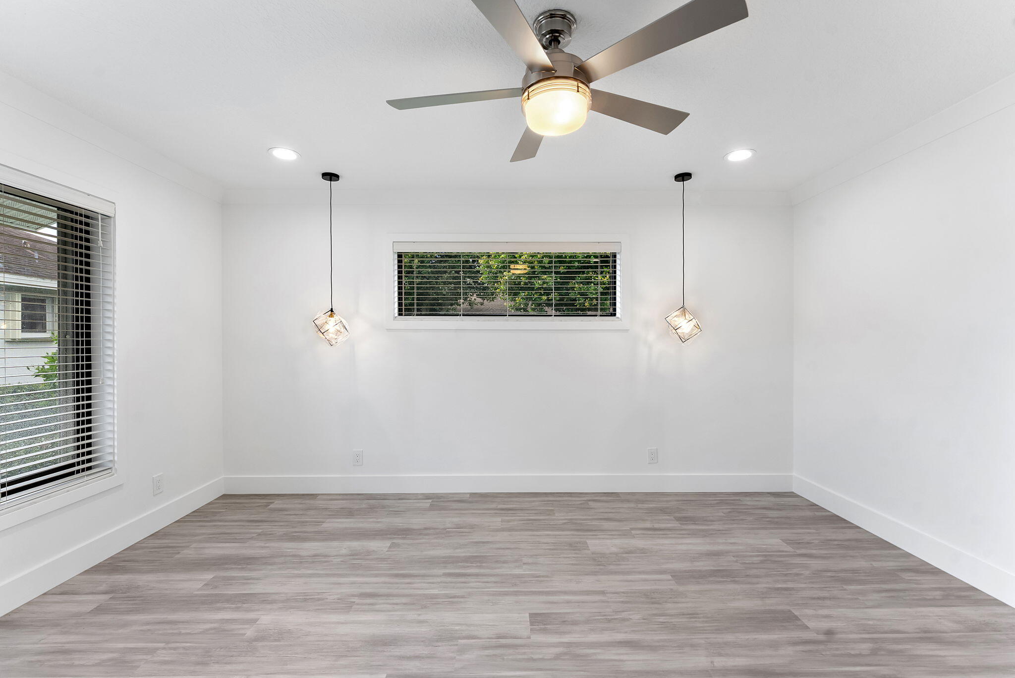 9840 Chestnut Tree Terrace, Unit A Boynton Beach, FL 33436 - Photo 24 of 27 an empty room with wooden floor fan and windows