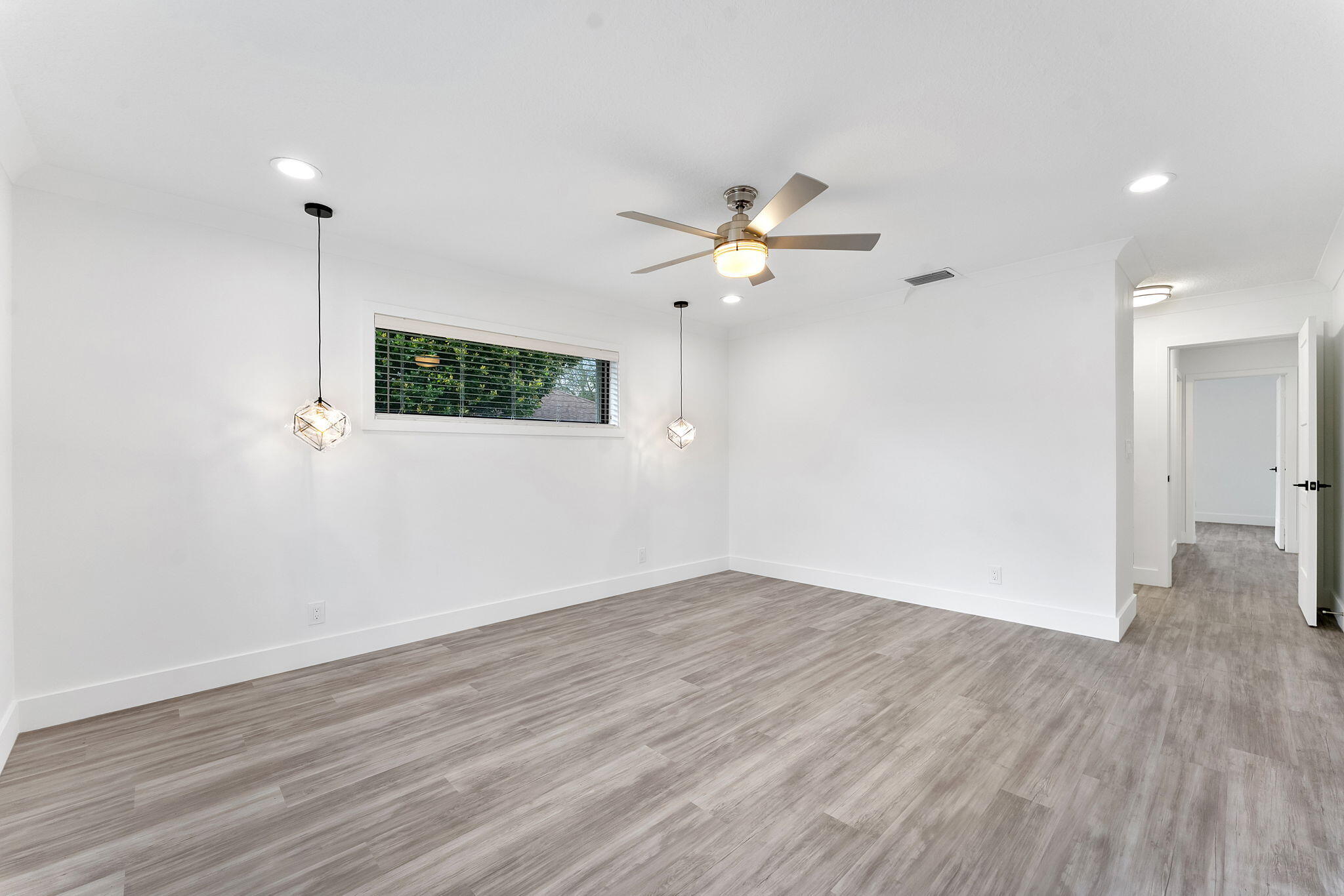 9840 Chestnut Tree Terrace, Unit A Boynton Beach, FL 33436 - Photo 25 of 27 a view of a room with wooden floor and ceiling fan