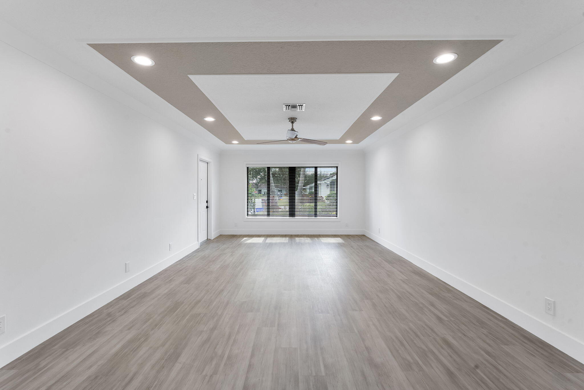 9840 Chestnut Tree Terrace, Unit A Boynton Beach, FL 33436 - Photo 3 of 27 an empty room with wooden floor and windows