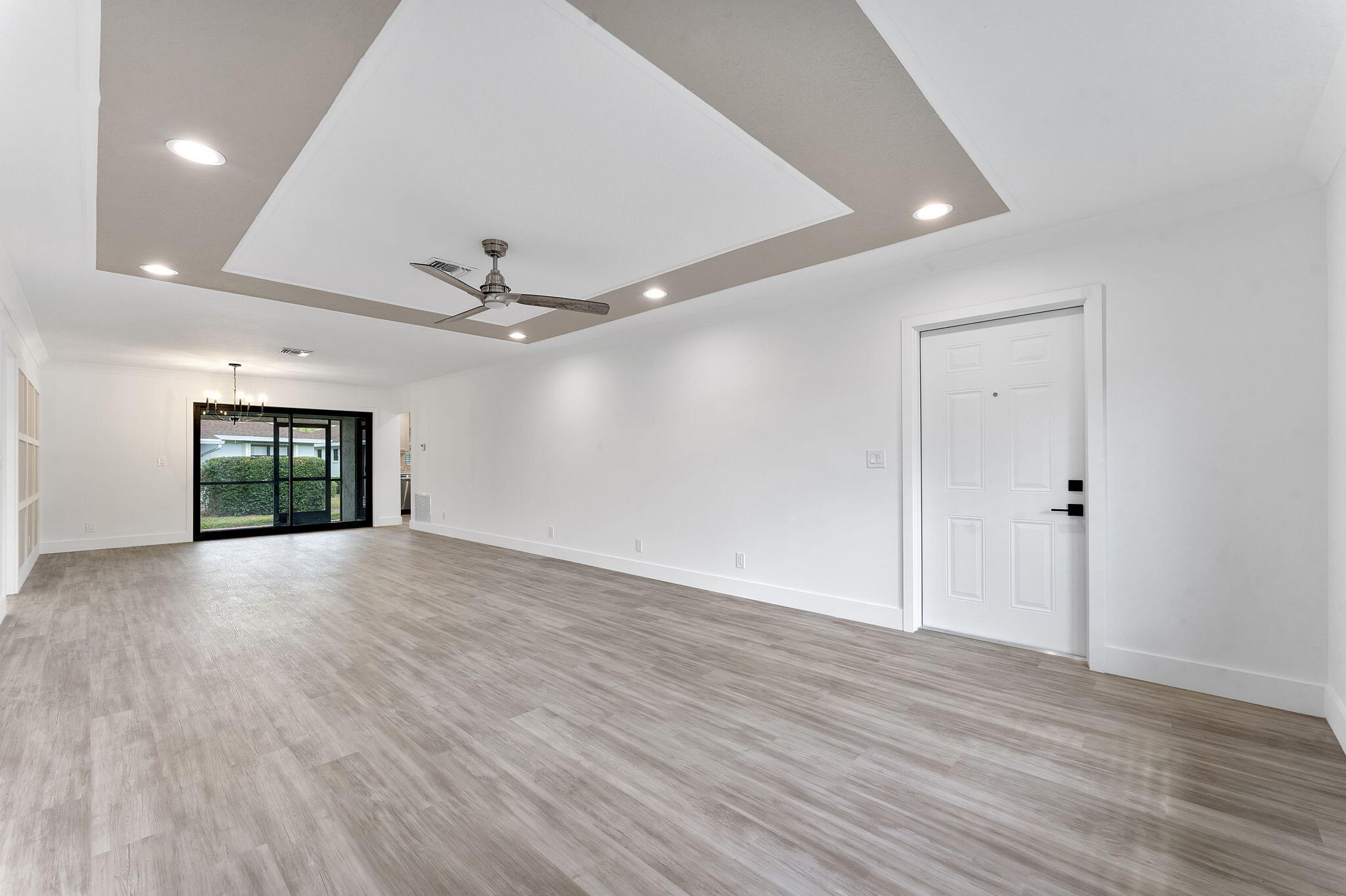 9840 Chestnut Tree Terrace, Unit A Boynton Beach, FL 33436 - Photo 5 of 27 a view of an empty room with window and wooden floor