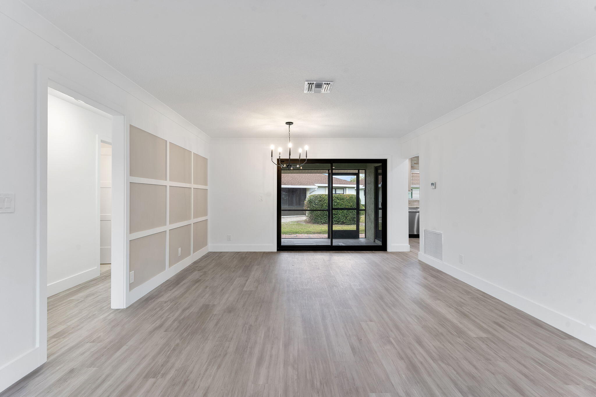 9840 Chestnut Tree Terrace, Unit A Boynton Beach, FL 33436 - Photo 6 of 27 an empty room with wooden floor and windows