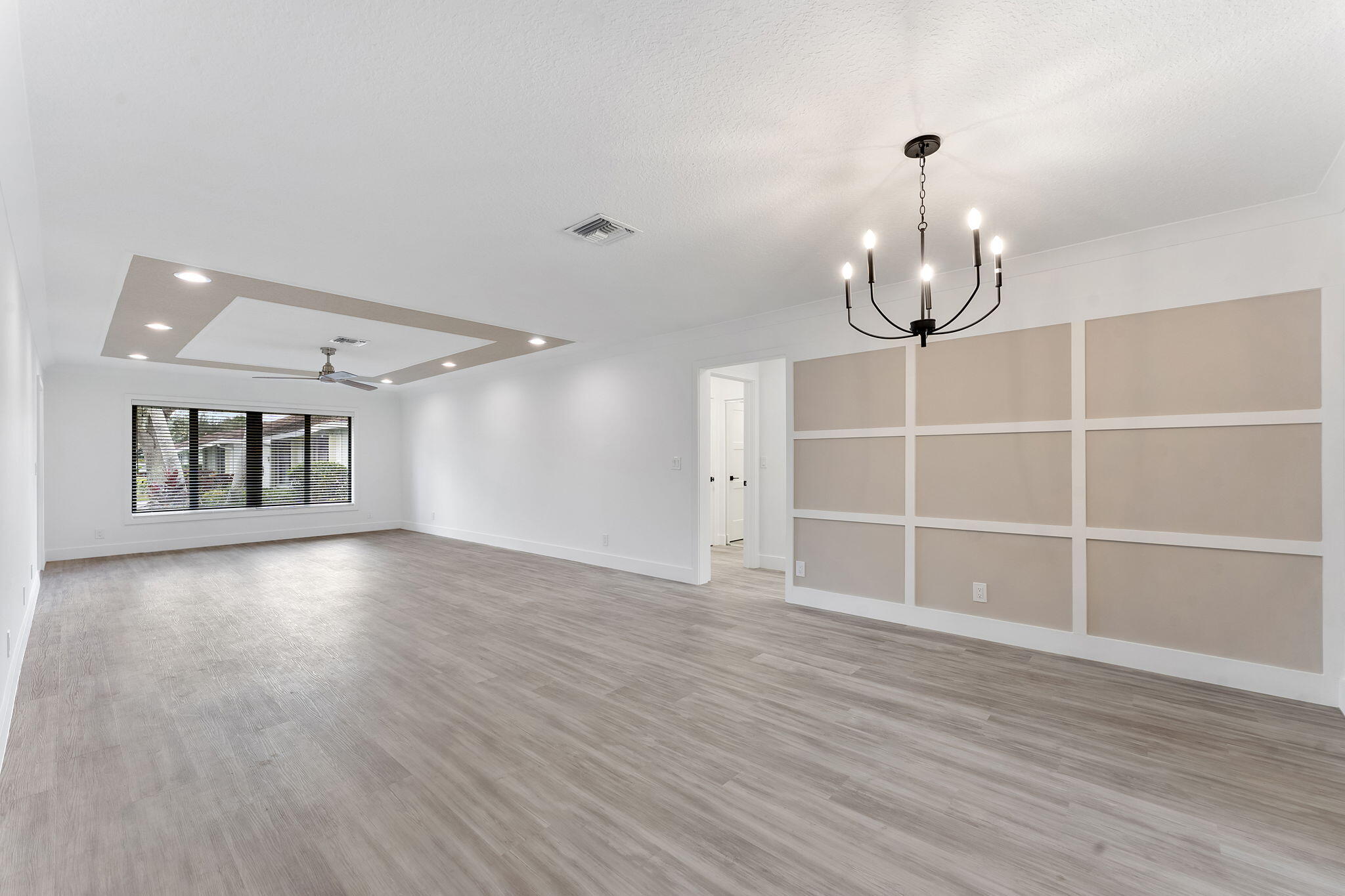 9840 Chestnut Tree Terrace, Unit A Boynton Beach, FL 33436 - Photo 8 of 27 a view of an empty room with wooden floor and a window