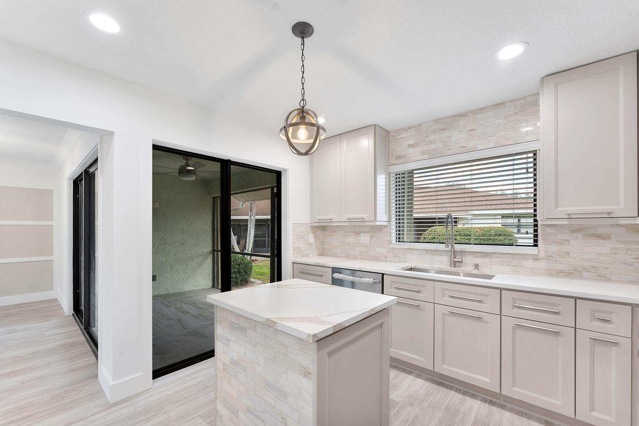 9840 Chestnut Tree Terrace, Unit A Boynton Beach, FL 33436 - Photo 9 of 27 a kitchen with a sink stove and refrigerator