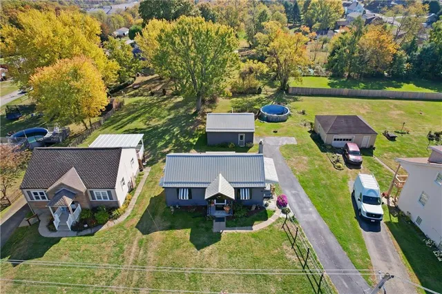 an aerial view of a house with swimming pool garden and patio