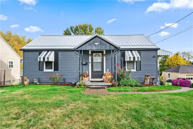 a front view of a house with a garden and plants